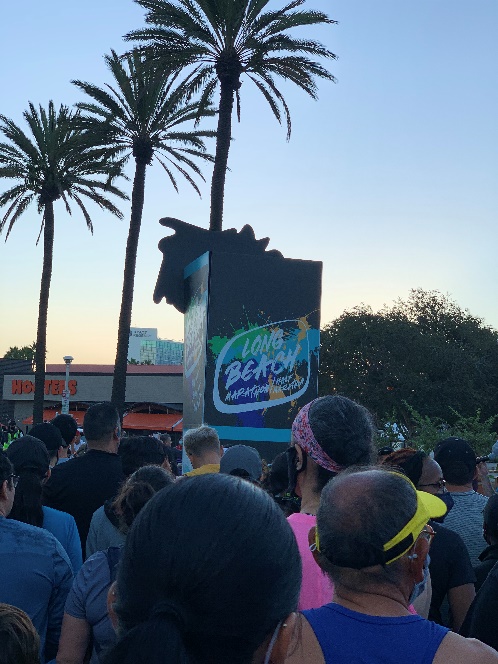 Group of runners waiting next to the Long Beach 5k sign