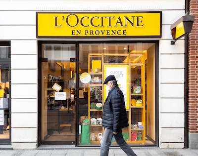 Man walking past a storefront