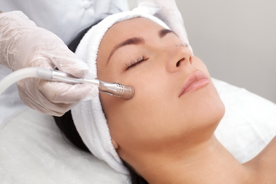 Woman undergoing a laser facial treatment for hyperpigmentation