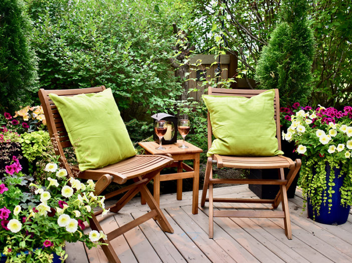 Sheltered outdoor garden patio oasis for afternoon backyard relaxation and glass of wine on warm seasonal summer days