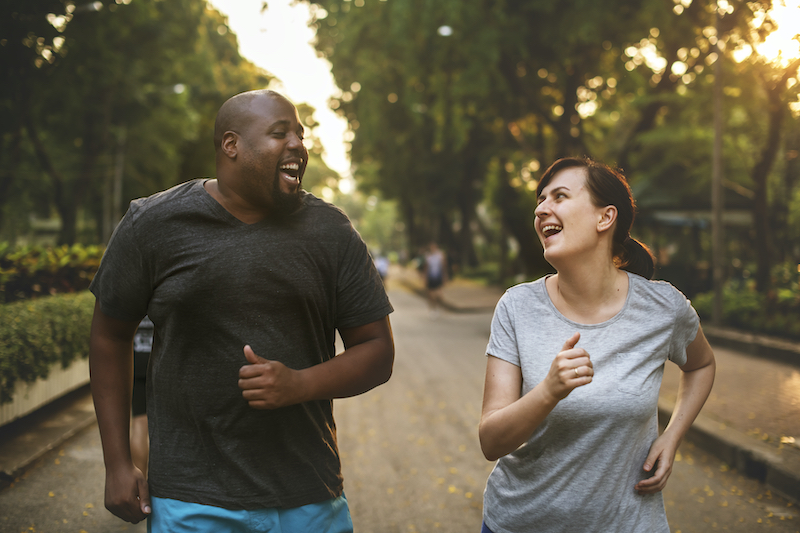 Middle-aged man and woman jogging side by side