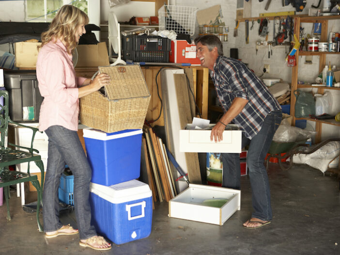 A couple organizing boxes in their garage
